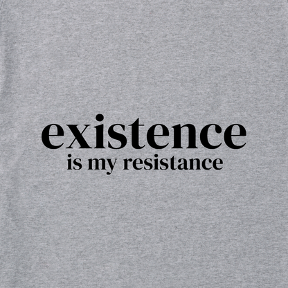 Image of grey t-shirt material with the words 'Existence is My Resistance' in black in the middle of the image.