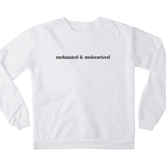 Digital mockup of a white crewneck sweatshirt with 'Melanated & Moisturized' written in the middle in black.