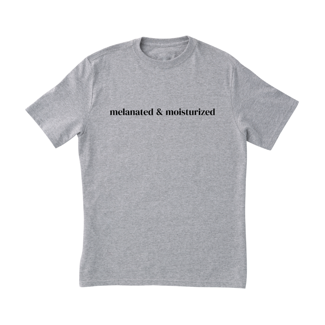 Digital mockup of a grey t-shirt with 'Melanated & Moisturized' written in the middle in black.